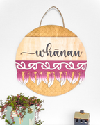 The Feather Round wall art complete with the word 'whānau' in a script font, made from natural plywood and hand-painted with a traditional Māori pattern or motif, in the colour Burgundy.