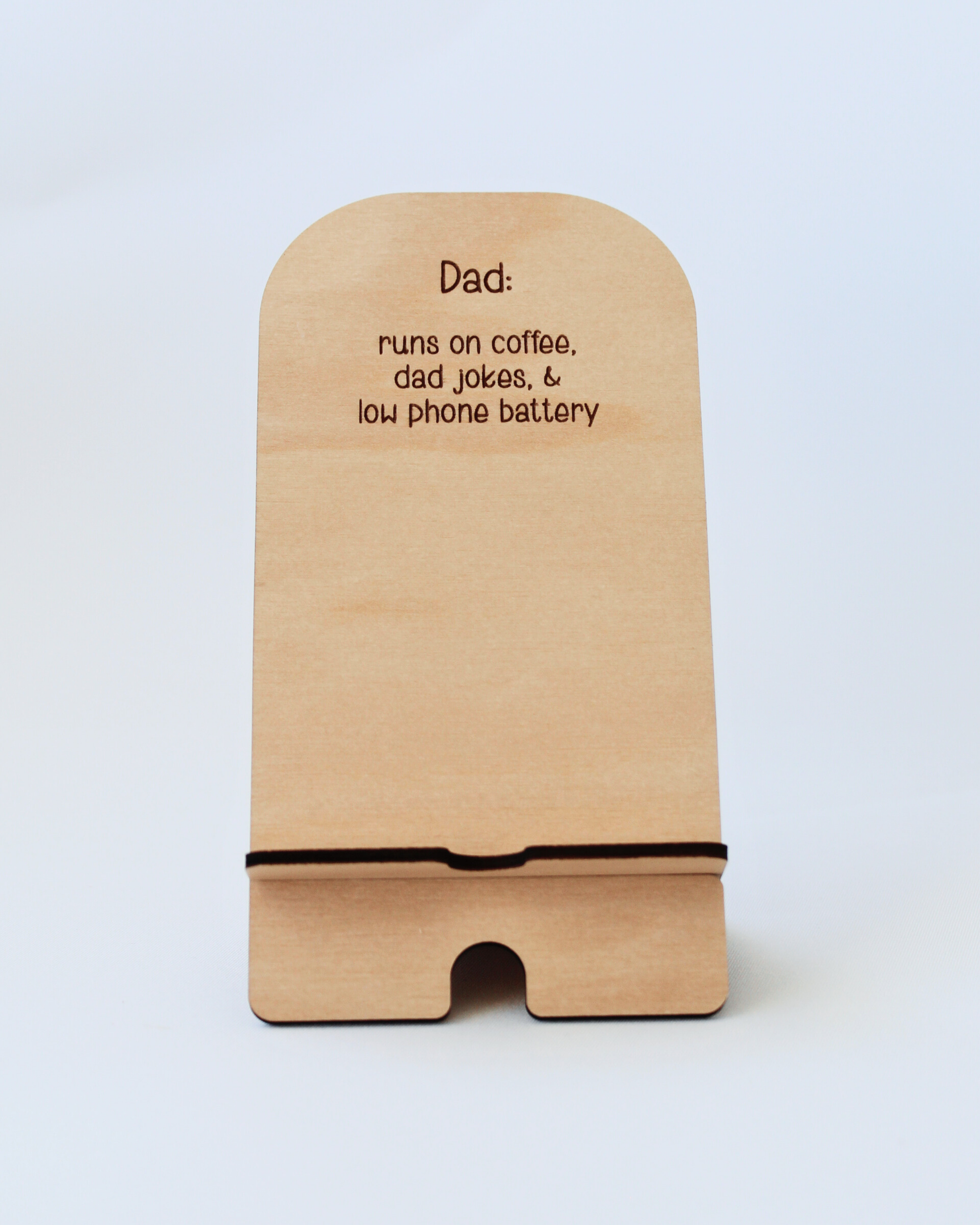 Wooden Phone Stand in the Dad Jokes design against a white background.