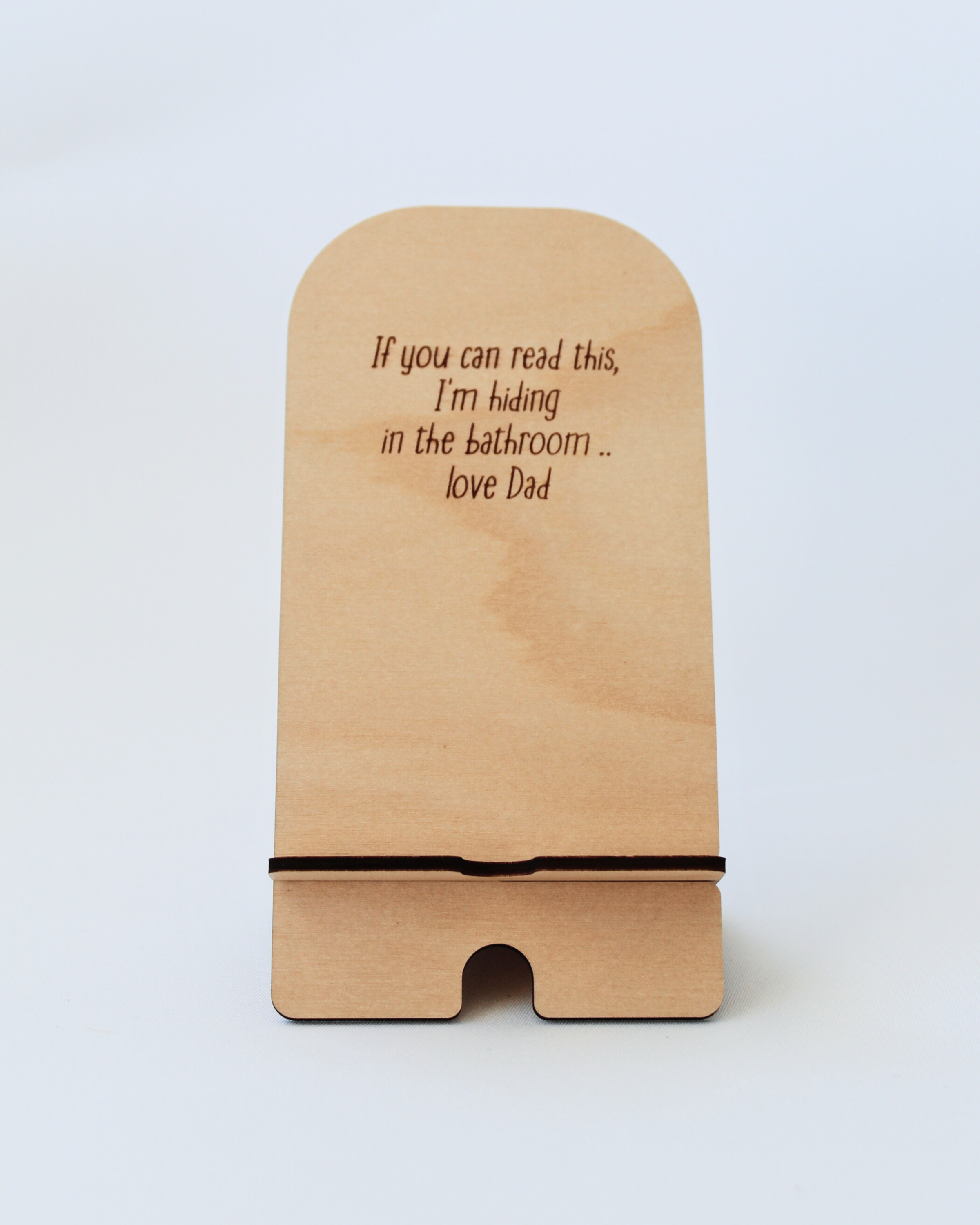 Wooden Phone Stand in the Hiding Dad design against a white background.